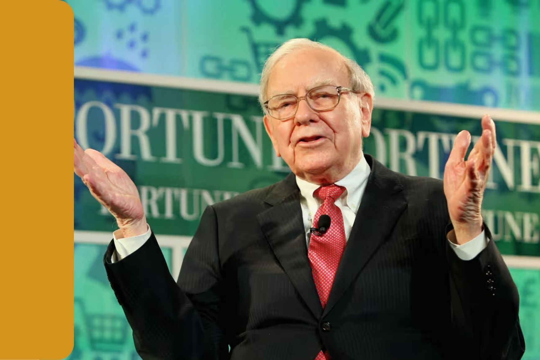 Warren Buffett stands on stage to address a crowd
